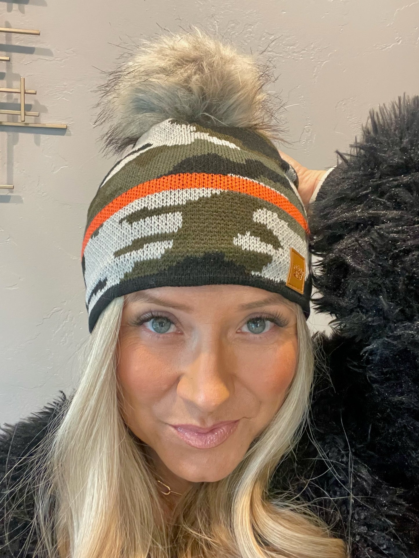 Adorable fleece lined green camouflage knit pom beanie with orange stripe